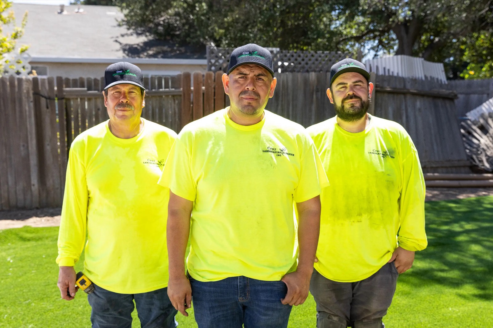 The Cruz Landscaping and Design crew in their work shirts