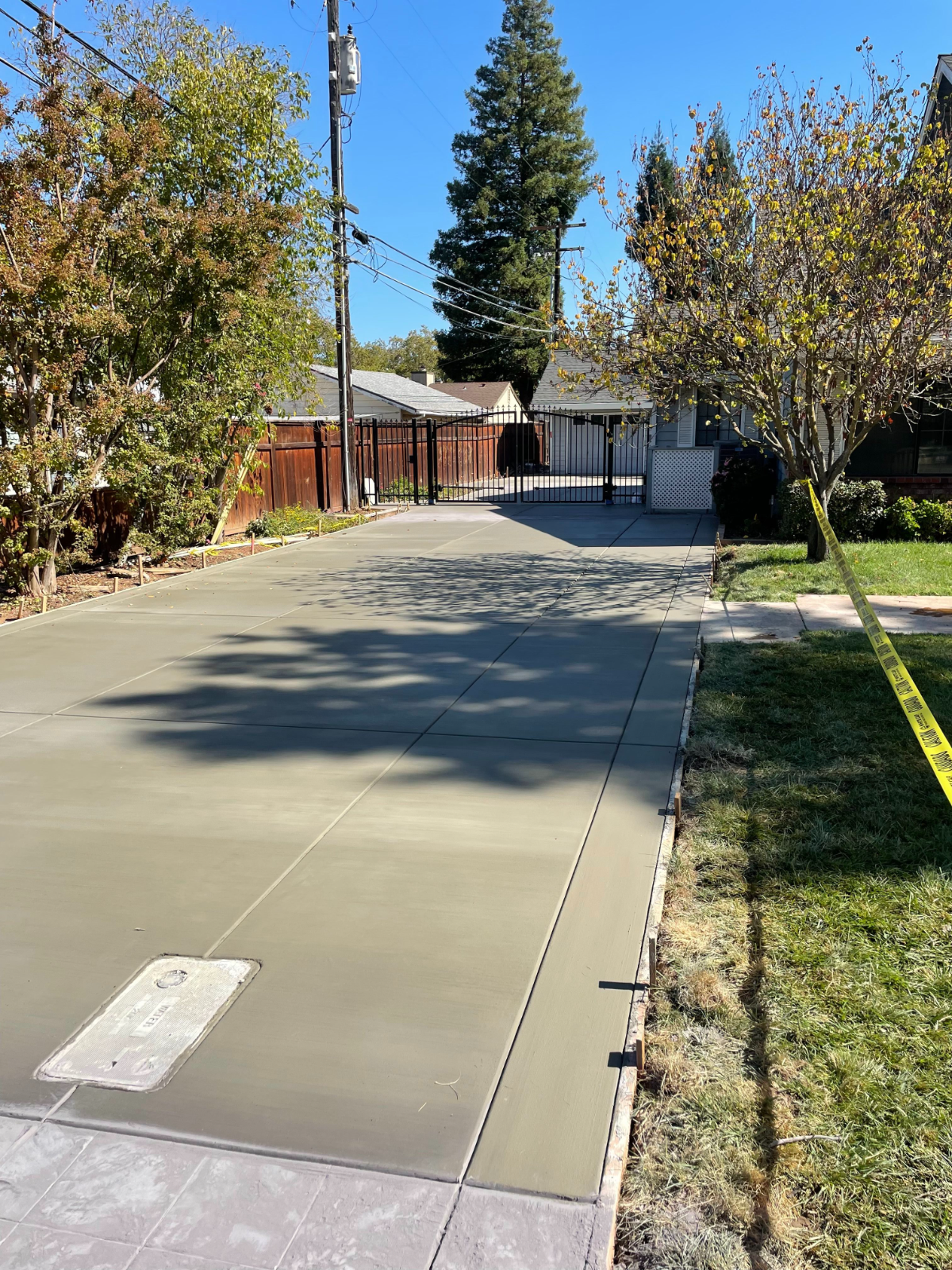 Finished concrete driveway with gate in Sacramento, CA