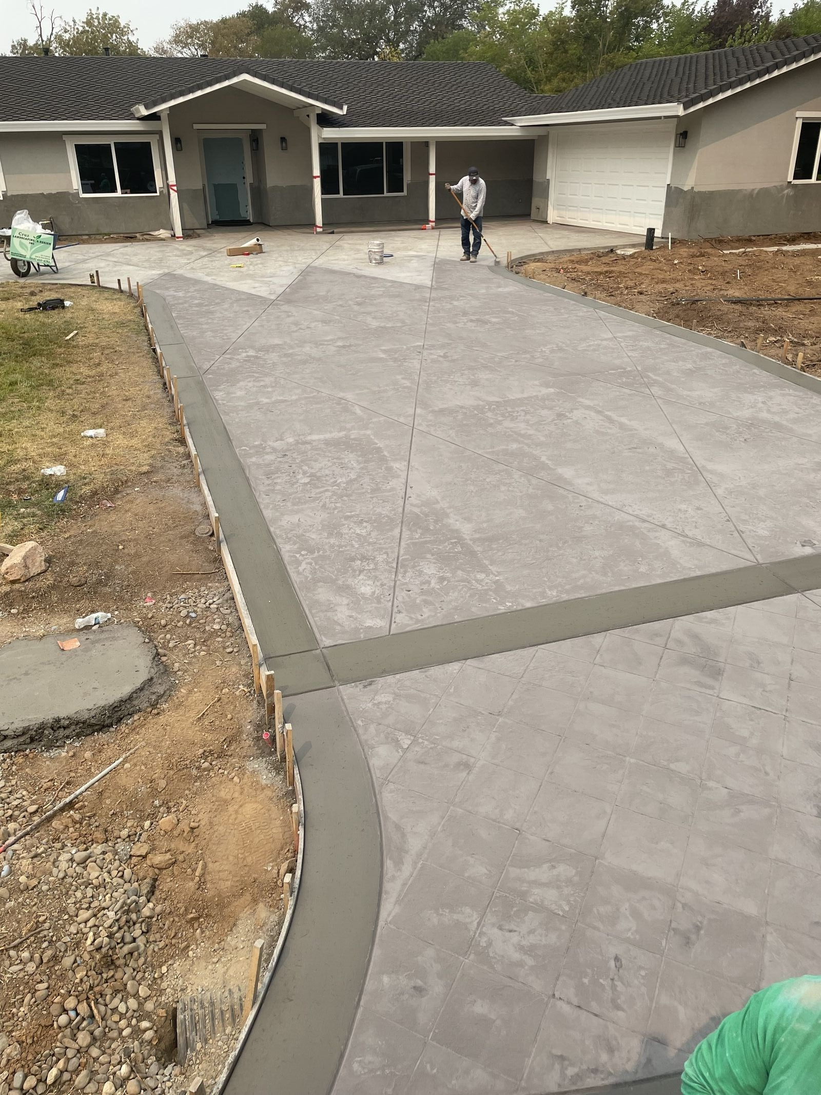 Cruz Landscaping and Design crew finishing a new concrete driveway in Sacramento, CA